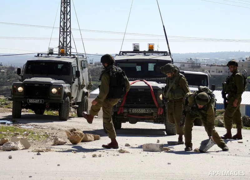 Israeli soldiers stand guards during a demonstration Palestinian, Israeli and International protesters against Israel's controversial separation barrier in the West Bank village of Maasarah, near the biblical town of Bet...