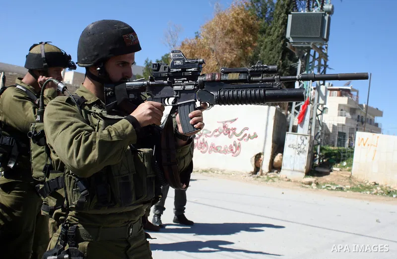 Israeli soldiers fire tear gas canisters towards Palestinian ,Israelian and International protesters during a demonstration against Israel's controversial separation barrier in the West Bank village of Maasarah, near the...