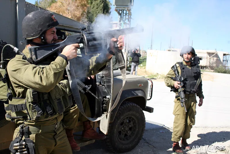 Israeli soldiers fire tear gas canisters towards Palestinian ,Israeli and International protesters during a demonstration against Israel's controversial separation barrier in the West Bank village of Maasarah, near the b...