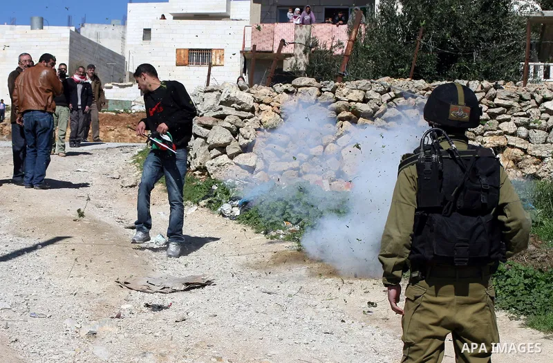 Israeli soldiers fire tear gas canisters towards Palestinian ,Israeli and International protesters during a demonstration against Israel's controversial separation barrier in the West Bank village of Maasarah, near the b...