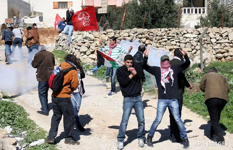 Israeli soldiers fire tear gas canisters towards Palestinian ,Israeli and International protesters during a demonstration against Israel's controversial separation barrier in the West Bank village of Maasarah, near the b...