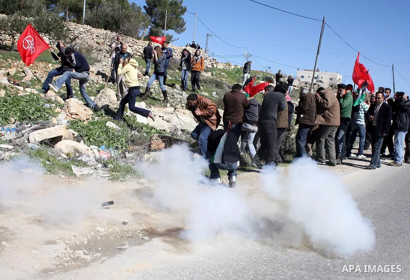 Israeli soldiers fire tear gas canisters towards Palestinian ,Israeli and International protesters during a demonstration against Israel's controversial separation barrier in the West Bank village of Maasarah, near the b...