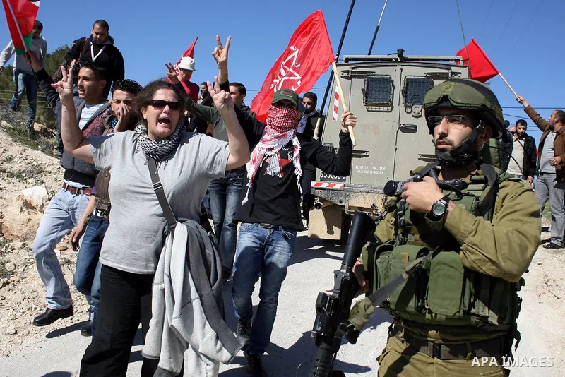 Palestinian, Israeli and International protesters take part in a demonstration against Israel's controversial separation barrier in the West Bank village of Maasarah, near the biblical town of Bethlehem on 18 February 20...