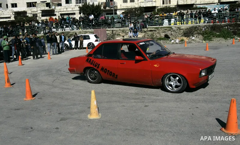 A Palestinian driver takes part in car race in the West Bank city of Nablus, Friday, Feb, 18, 2011. Photo by Wagdi Eshtayah