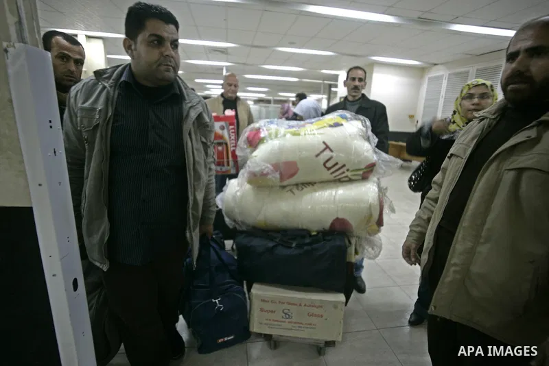 Palestinians Leaving the Hall travelers after coming back from Egypt at the Rafah border crossing between southern Gaza Strip and Egypt, Friday, Feb. 18, 2011. The Rafah border crossing opened on Friday evening for the f...