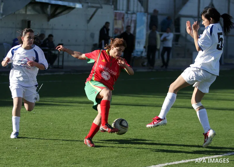 Palestinians play a football match between Deyaar team (red) and Al-Rwaa team (white) in the West Bank city of Bethlehem on Feb. 18, 2011. Within the Premier League for females at the Al-Khader Stade. Photo by Najeh Hash...