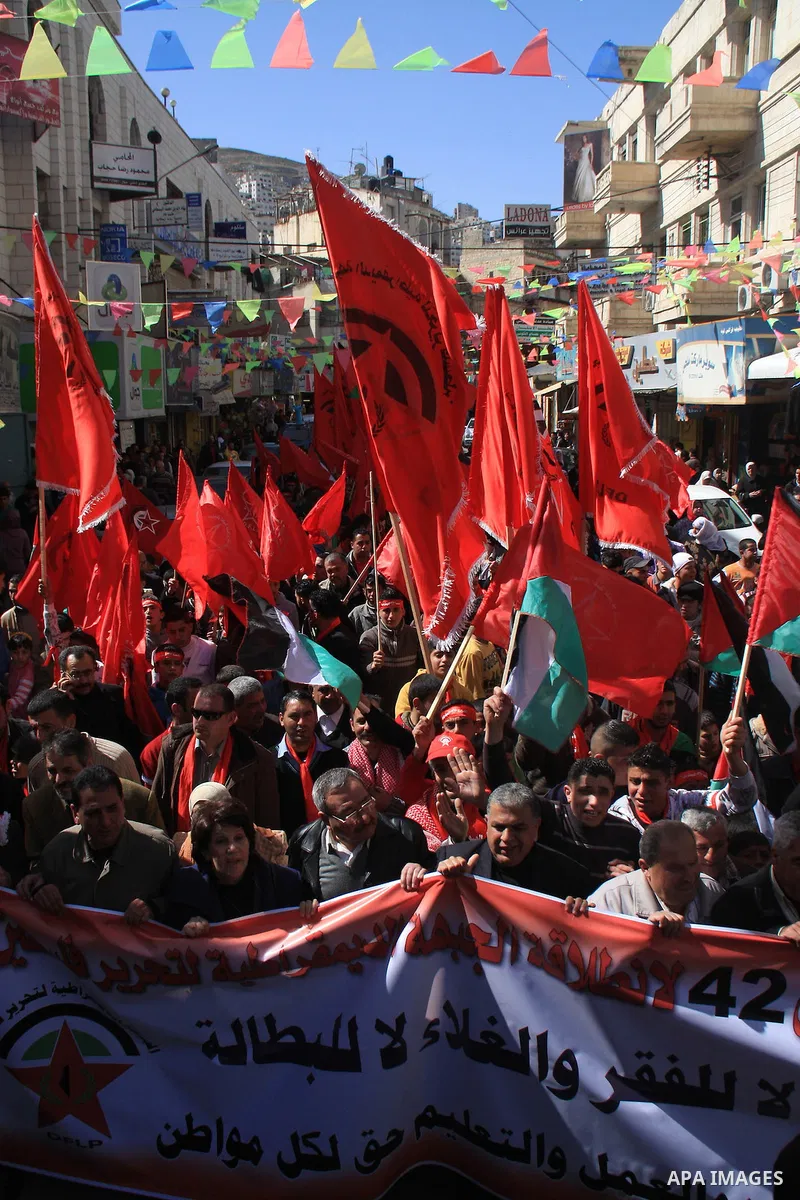 Palestinians take part during a demonstration calling to end the split between the West Bank and Gaza, marking the 42th anniversary of the Democratic Front for the Liberation of Palestine (DFLP) in the West Bank city of...