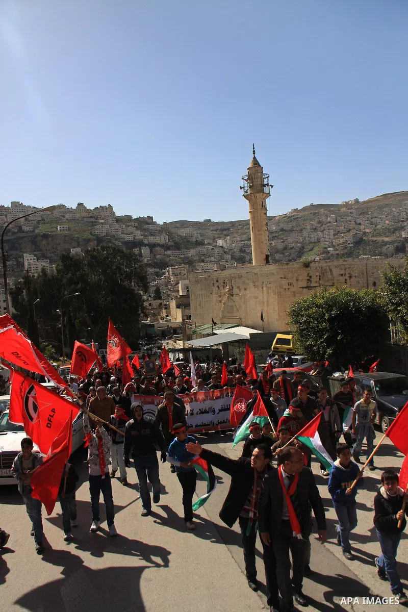 Palestinians take part during a demonstration calling to end the split between the West Bank and Gaza, marking the 42th anniversary of the Democratic Front for the Liberation of Palestine (DFLP) in the West Bank city of...