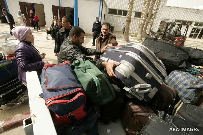 Palestinians returning from Egypt cross through the Rafah crossing on Feb. 19, 2011. The Egyptian authorities reopened the Rafah crossing on its border with the Gaza Stripe on Friday, the first time after the resignation...