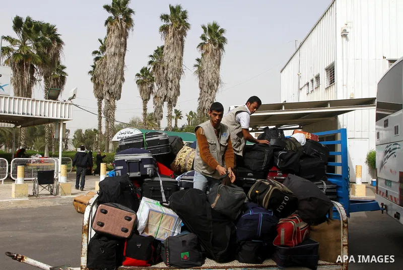 Palestinians returning from Egypt cross through the Rafah crossing on Feb. 19, 2011. The Egyptian authorities reopened the Rafah crossing on its border with the Gaza Stripe on Friday, the first time after the resignation...