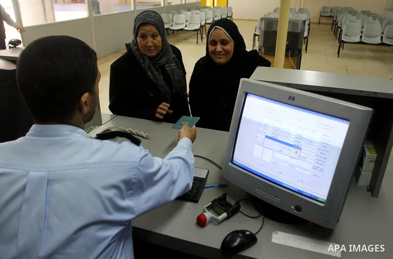 Hamas security officials check the travel documents of Palestinians upon their arrival to the Gaza Strip from the Rafah border terminal between Egypt and the coastal strip on February 19, 2011. Egypt reopened its Rafah b...