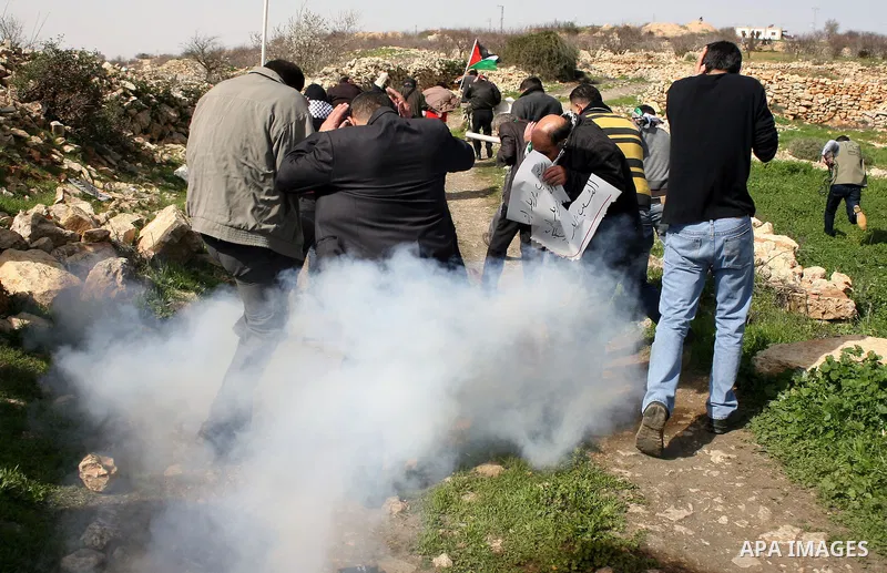 Israeli soldiers fire tear gas towards Palestinian ,Israeli and International protesters during a demonstration against the demolishing of farm land to be used in the construction of Jewish settlements near the existing...