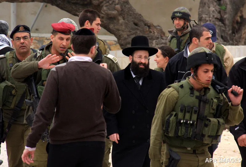 An Israeli Jewish rabbi walks at the entrance of the tomb of the Biblical figure Yehoshua Bin Nun, also know as Joshua, in the West Bank village of Kifl Hareth, near Nablus, Sunday, Feb 20,2011. Photo by Wagdi Eshtayah