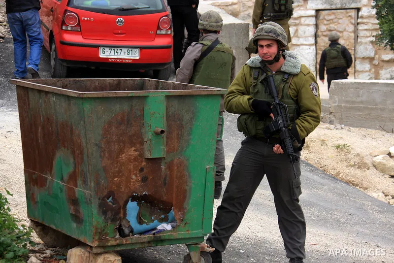 Israeli soldiers stand guard as Jewish rabbi visits the tomb of the Biblical figure Yehoshua Bin Nun, also know as Joshua, in the West Bank village of Kifl Hareth, near Nablus, Sunday, Feb 20,2011. Photo by Wagdi Eshtaya...