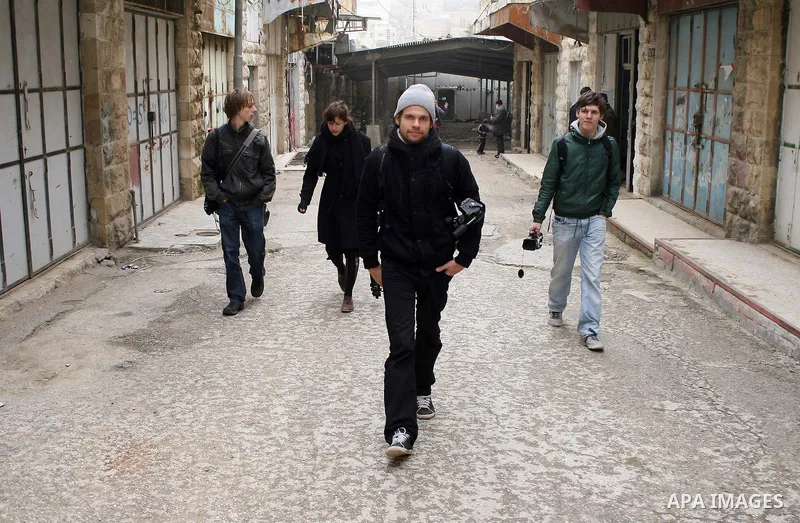 Foreigners shop in a traditional market at the old city in the West Bank city of Hebron on February 20, 2011. Photo by Najeh Hashlamoun