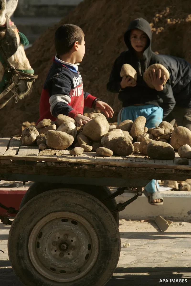 Palestinian children extract the stone from the sand, To re-manufacture a new block in the Rafah refugee camp southern Gaza Strip on February 21, 2011. Because of the Israeli siege and closure of the crossings and preven...