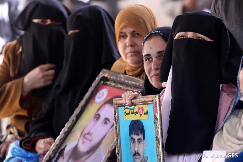 Palestinian women hold pictures of jailed relatives during a protest calling for the release of Palestinian prisoners from Israeli jails at the Red Cross office in Gaza City on Feb. 21, 2011. Photo by Mohammed Asad
