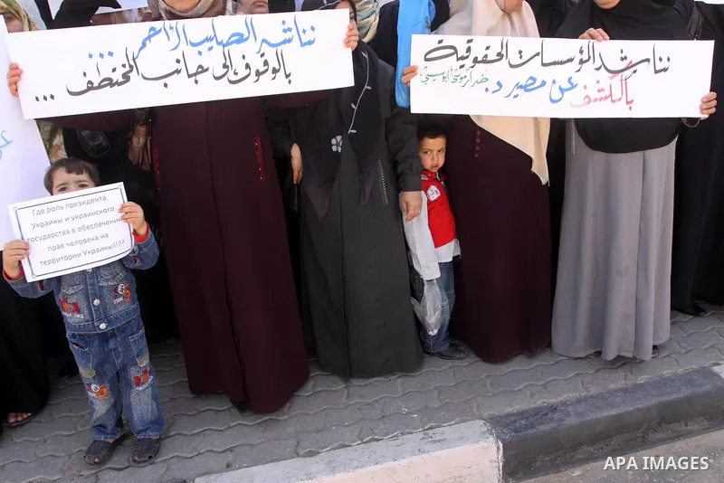 Palestinians demonstrate during a protest to show solidarity with Derar Abu Sissi family, who was kidnapped by an unidentified people in Ukraine, in front of Red Cross building, Gaza City on Feb. 22, 2011. Photo by Moham...