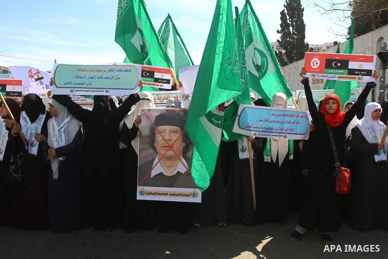 Palestinian students hold up placards during a protest against Libyan leader Moamer Kadhafi, in Gaza City on February 22, 2011. Gaza's Hamas rulers heaped condemnation on "the massacres" of anti-government protestors in...
