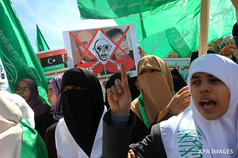 Palestinian students hold up placards during a protest against Libyan leader Moamer Kadhafi, in Gaza City on February 22, 2011. Gaza's Hamas rulers heaped condemnation on "the massacres" of anti-government protestors in...