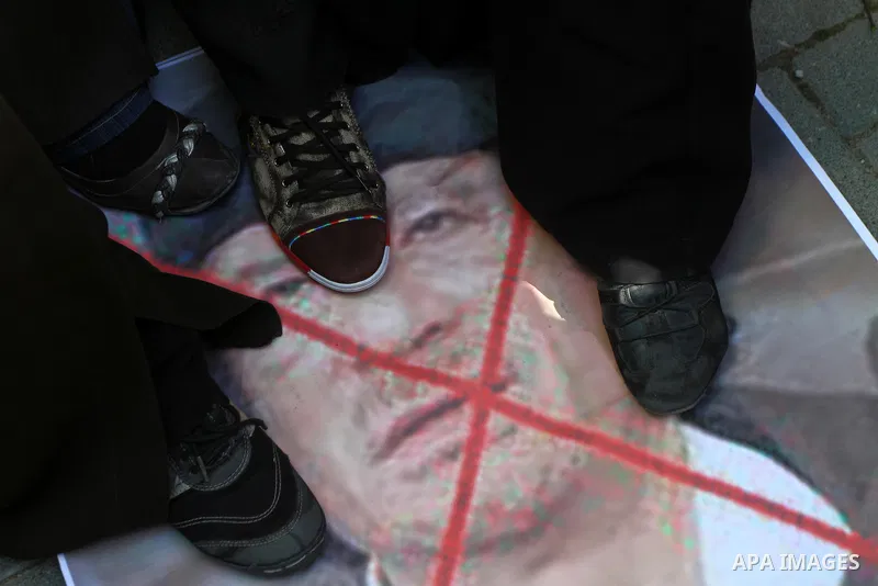 Palestinians step on a poster of Libyan leader Moammar Gadhafi during a march in solidarity with Libya in Gaza City, Tuesday, Feb. 22 , 2011. Gadhafi's 42-year rule is under unprecedented pressure from an uprising that i...