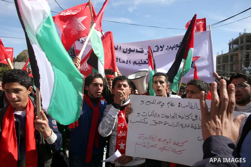 Palestinian universities students take part in a protest calling for the adoption of the National Fund for Education in the West Bank city of Ramallah on Feb. 22,2011. Photo by Issam Rimawi