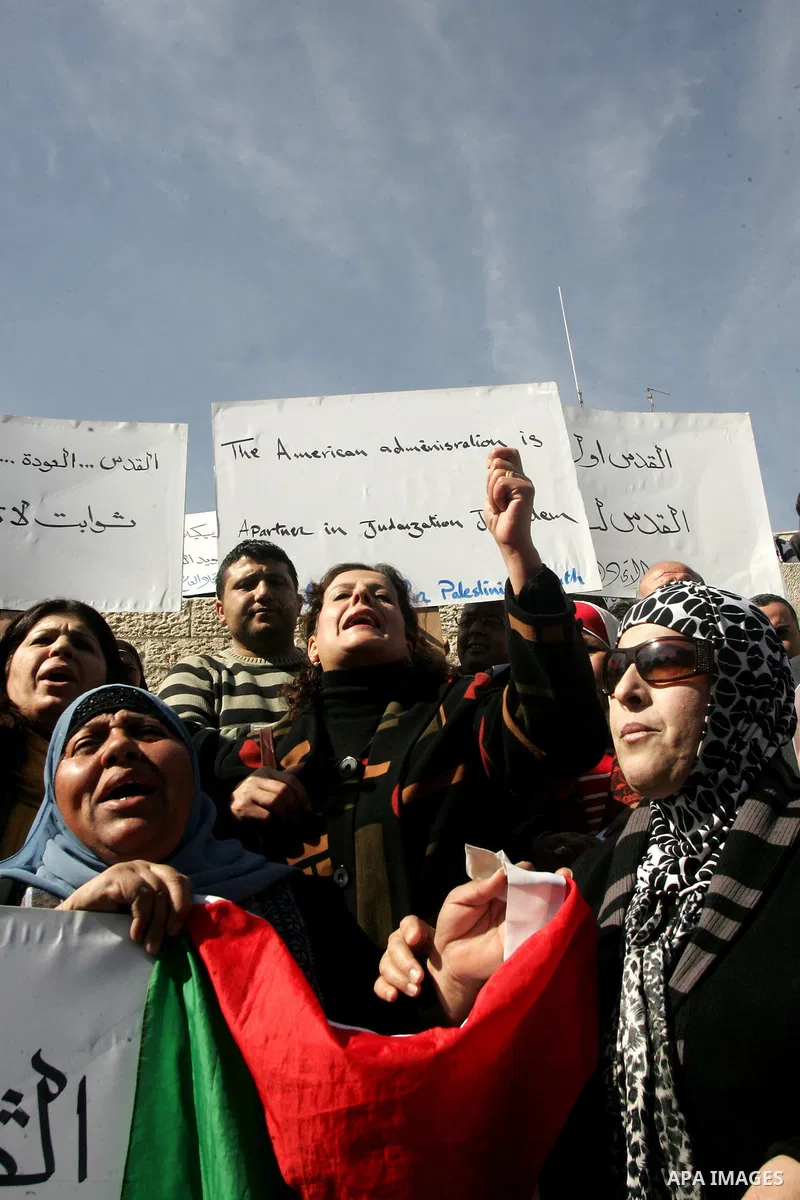 Palestinians take part in a demonstration against the United States' recent veto in the UN Security Council dealing with Israeli settlements in the West Bank, as they protest at the Damascus Gate in East Jerusalem on 22...