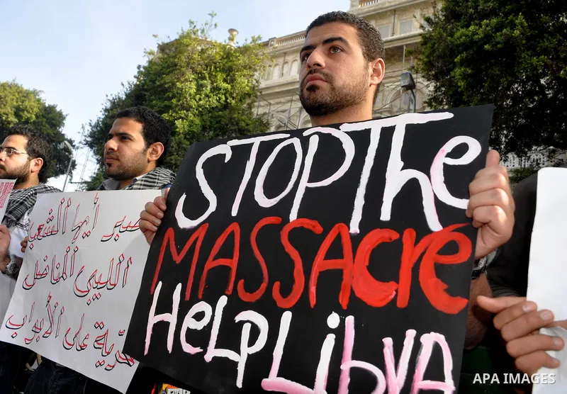 Protesters take part in a protest against Libyan Leader Moammar Gadhafi in front of the Arab league in Cairo, Egypt, Feb. 22, 2011. Protesters gathered at the protest against Gadhafi's crackdown on peaceful protesters in...