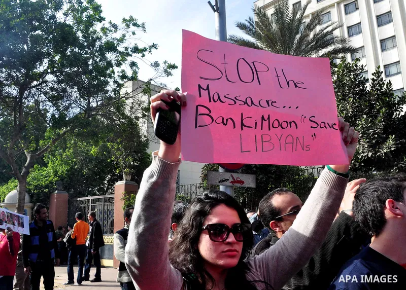 Protesters take part in a protest against Libyan Leader Moammar Gadhafi in front of the Arab league in Cairo, Egypt, Feb. 22, 2011. Protesters gathered at the protest against Gadhafi's crackdown on peaceful protesters in...
