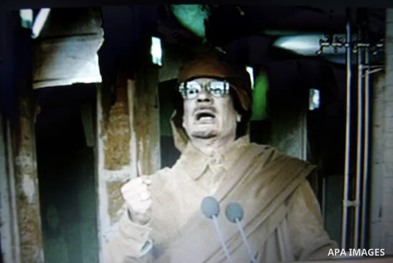 A picture taken from a Libyan State TV, on February 22, 2011 showing Libyan leader Muammar Gaddafi speaks on Libyan state television. Libyan leader Muammar Gaddafi said he will not step down, in an address broadcast on s...