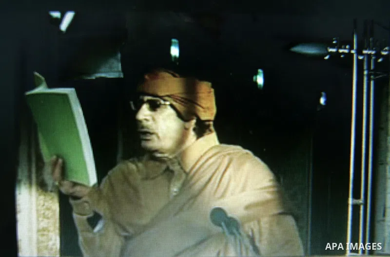 A picture taken from a Libyan State TV, on February 22, 2011 showing Libyan leader Muammar Gaddafi speaks on Libyan state television. Libyan leader Muammar Gaddafi said he will not step down, in an address broadcast on s...