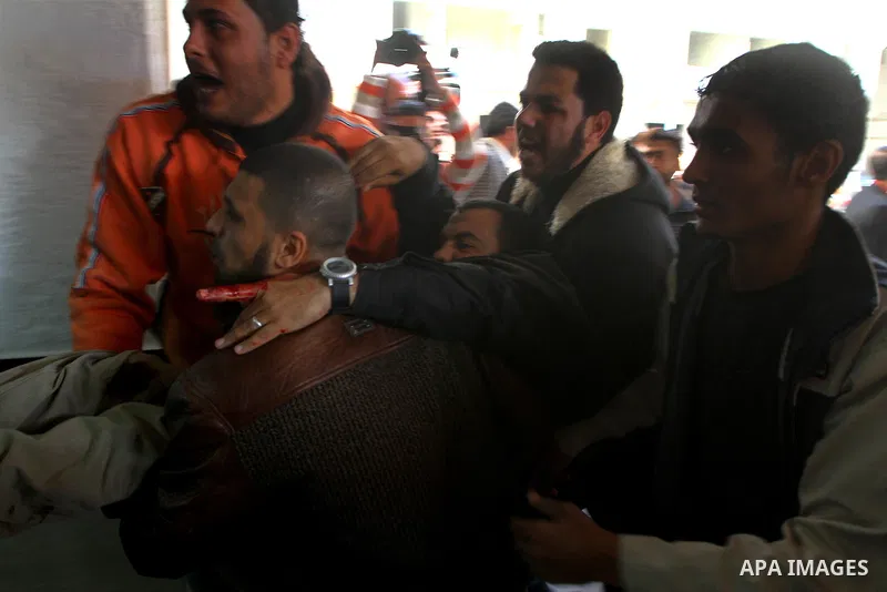 Palestinians carry a wounded man into al-Shefa hospital in Gaza City on Feb. 23, 2011. Eleven Palestinians were wounded Wednesday by Israeli artillery shelling in Gaza City, witnesses and medical sources said. Photo by A...