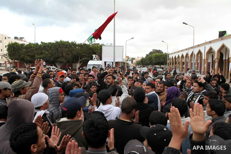 People attend a protest in the eastern Libyan town of Derna on Feb. 23, 2011. Unrest shook Libya in recent days as government crackdowns on protesters have resulted in mass casualties, according to human rights groups. P...