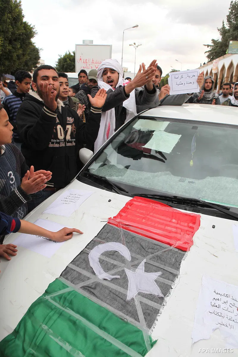 People attend a protest in the eastern Libyan town of Derna on Feb. 23, 2011. Unrest shook Libya in recent days as government crackdowns on protesters have resulted in mass casualties, according to human rights groups. P...