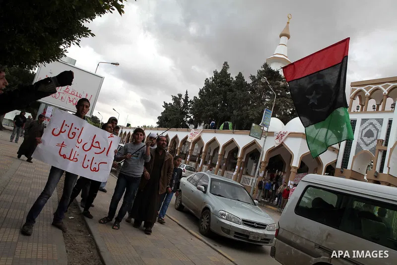 People attend a protest in the eastern Libyan town of Derna on Feb. 23, 2011. Unrest shook Libya in recent days as government crackdowns on protesters have resulted in mass casualties, according to human rights groups. P...
