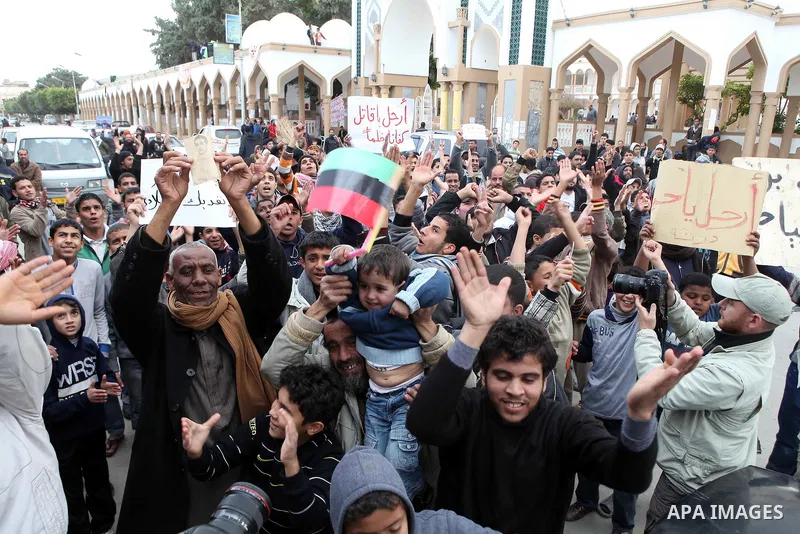 People attend a protest in the eastern Libyan town of Derna on Feb. 23, 2011. Unrest shook Libya in recent days as government crackdowns on protesters have resulted in mass casualties, according to human rights groups. P...