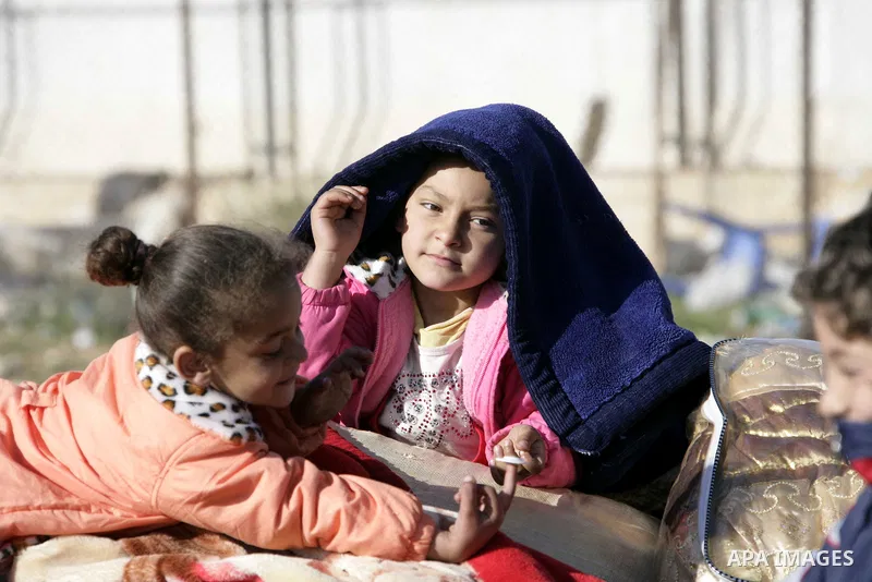 Egyptians, who have fled from Libya through the Salloum land port gate wait with their luggage,Wednesday, Feb. 23, 2011. An estimated 5,000 Egyptians have returned home from Libya by land, and about 10,000 more are waiti...
