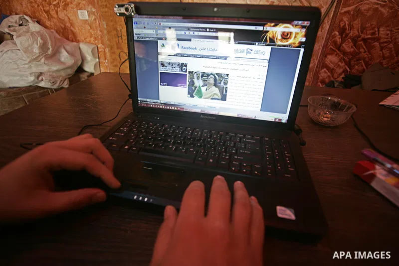 A Palestinian man looks at the computer to follow the hot events in Libya, in Rafah, southern Gaza Strip on February 24, 2011. Palestinian sources confirmed Thursday morning that the Libyan leader Muammar Gaddafi has thr...