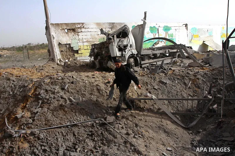 A Palestinian man surveys the damage the morning after an Israeli air strike in the Gaza Strip February 24, 2011. A rocket launched from the Gaza Strip landed in a residential street in the Israeli city of Beersheba Wedn...