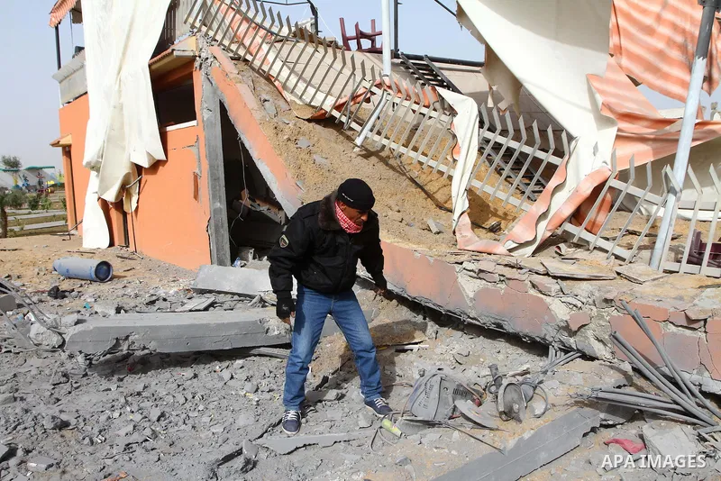 A Palestinian surveys the damage the morning after an Israeli air strike in the Gaza Strip February 24, 2011. A rocket launched from the Gaza Strip landed in a residential street in the Israeli city of Beersheba Wednesda...