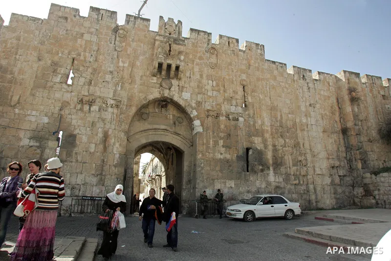 Palestinians and foreigners walk past the Lion Gate, just outside Jerusalem's Old City on Feb. 24, 2011. Photo by Mahfouz Abu Turk