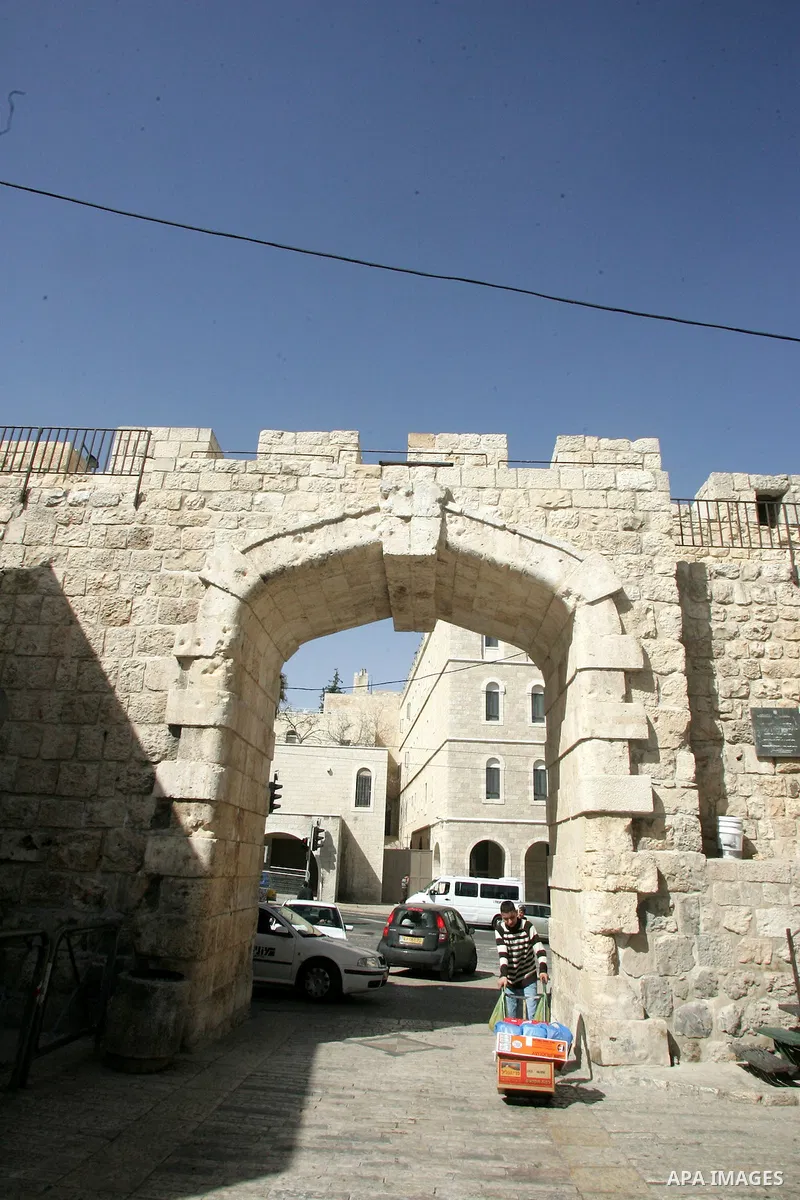 A Palestinian boy walks past the New gate as known to Palestinians "Bab al-Jedid", just outside Jerusalem's Old City on Feb. 24, 2011. Photo by Mahfouz Abu Turk