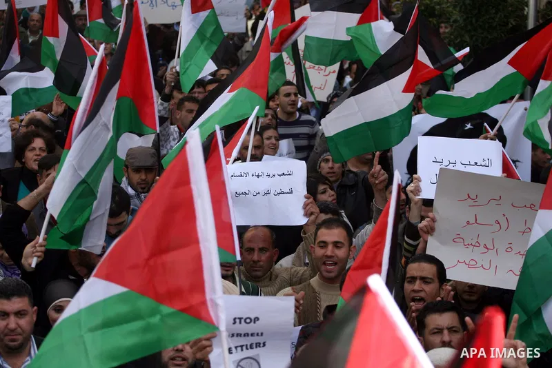 Palestinians take part in a rally calling for ending the Palestinian division, in the West Bank city of Ramallah on Feb.24, 2011. More than 3000 protesters call for free elections and the reconciliation between the two r...