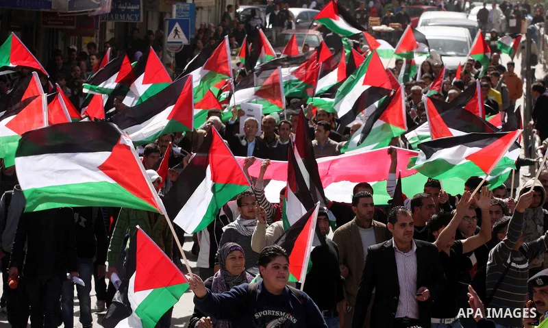 Palestinians take part in a rally calling for ending the Palestinian division, in the West Bank city of Ramallah on Feb.24, 2011. More than 3000 protesters call for free elections and the reconciliation between the two r...