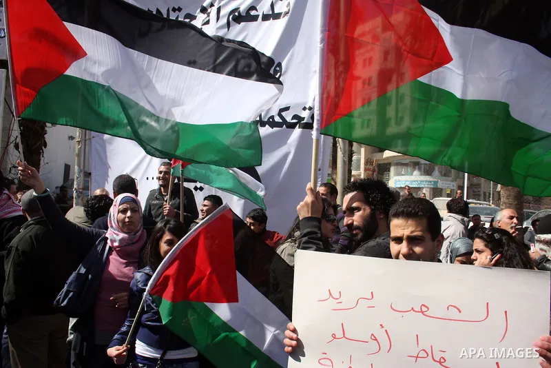 Palestinians take part in a rally calling for ending the Palestinian division, in the West Bank city of Ramallah on Feb. 24, 2011. More than 3000 protesters call for free elections and the reconciliation between the two...
