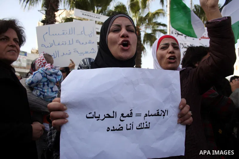 Palestinians take part in a rally calling for ending the Palestinian division, in the West Bank city of Ramallah on Feb. 24, 2011. More than 3000 protesters call for free elections and the reconciliation between the two...