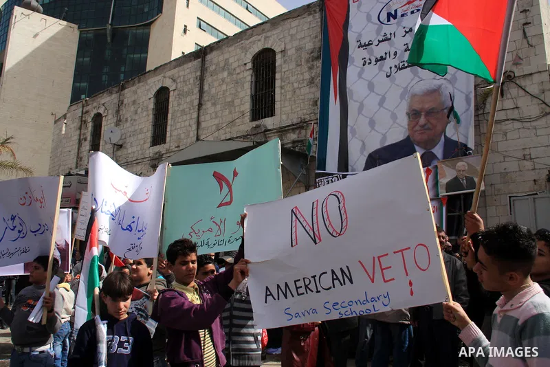 Palestinian protesters hold national flags and banners during a rally against the U.S. veto and calling for the national reconciliation in the West Bank city of Nablus, Thursday, Feb. 24, 2011. Photo by Wagdi Eshtayah