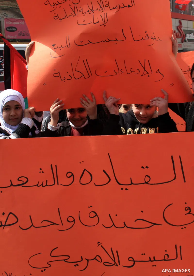 Palestinian protesters banners during a rally against the U.S. veto and calling for the national reconciliation in the West Bank city of Nablus, Thursday, Feb. 24, 2011. Photo by Wagdi Eshtayah