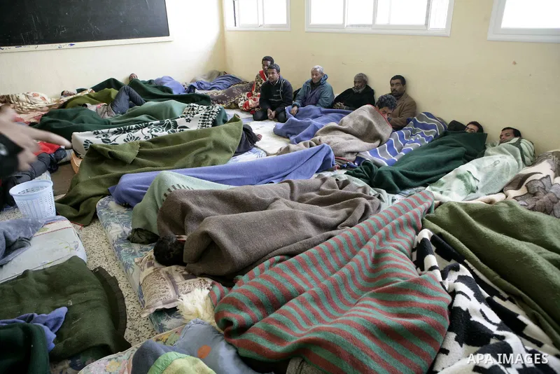 Suspected African mercenaries sit in a room in a school as they are held by anti-government protesters, in Albedia February 24, 2011. About a dozen people were being held in a school building who residents said were "mer...