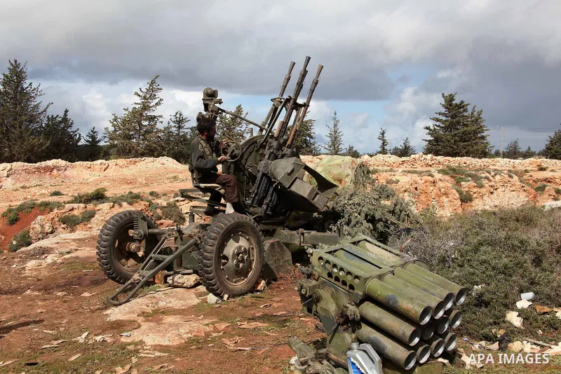 A Libyan gunman as he holds his automatic machine gun , in Albedia , Libya, on Thursday Feb. 24, 2011. A Libyan witness says a Libyan army unit has blasted a minaret of a mosque in a city west of Tripoli. The witness tel...